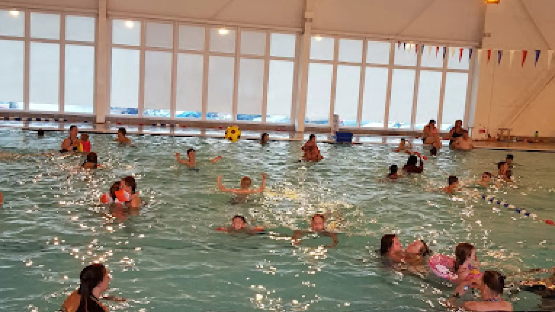 Families enjoying the large heated indoor pool at Brean Splash Waterpark Somerset.