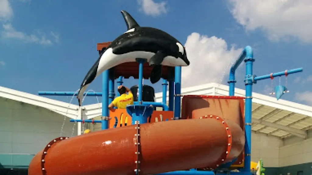 Orca water feature and large tube slide at the outdoor splash park in Brean Splash Waterpark Somerset.