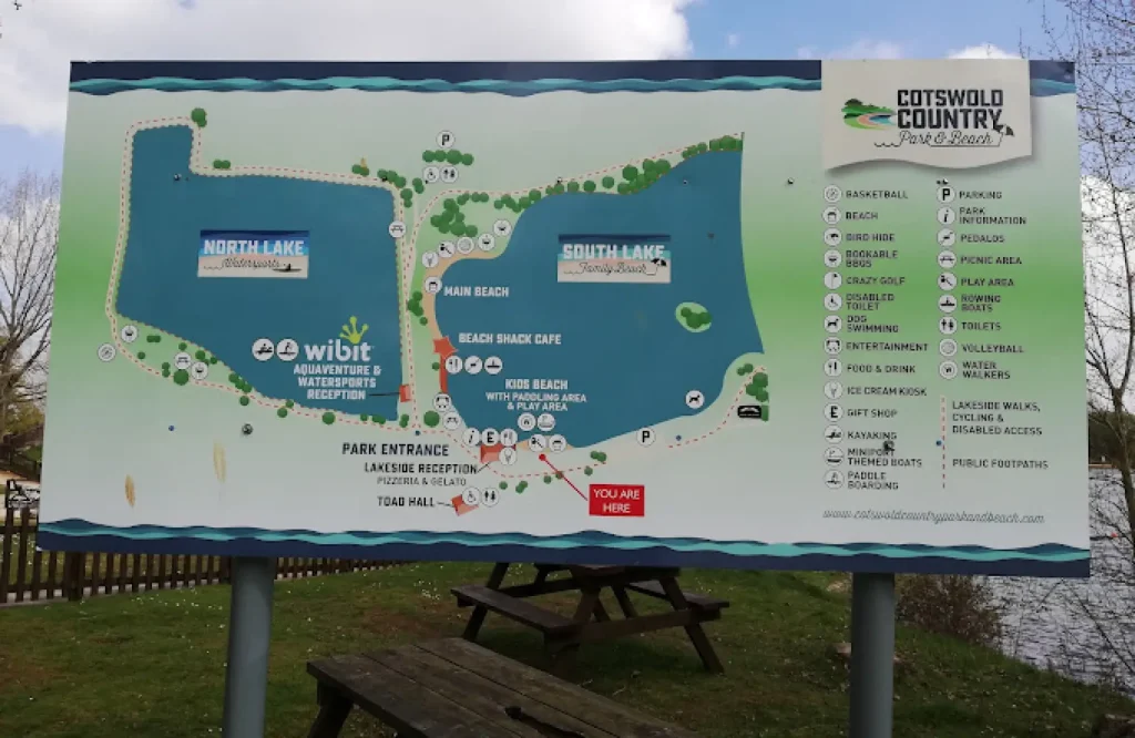 Illustrated map of Cotswold Country Park and Beach displaying North Lake, South Lake, activity zones, walking paths, picnic areas, and visitor amenities.