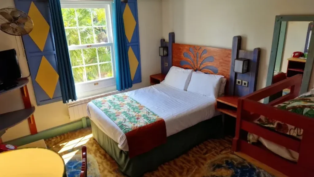 Brightly decorated family room with double bed and bunk beds at Alton Towers Hotel, featuring colourful theme and window view — one of the top-rated places to stay near Alton Towers.