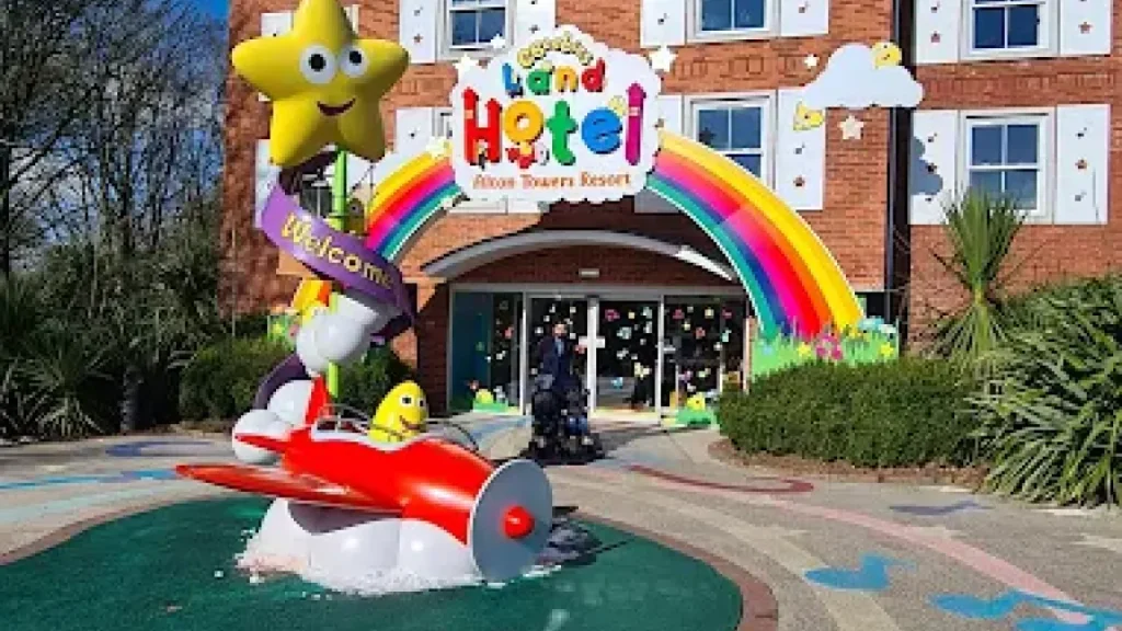 Colourful entrance of CBeebies Land Hotel at Alton Towers with rainbow arch, star mascot, and themed decorations