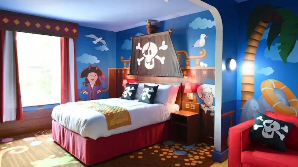 Colourful pirate-themed bedroom with cartoon mural, double bed, and ship-style decor at CBeebies Land Hotel