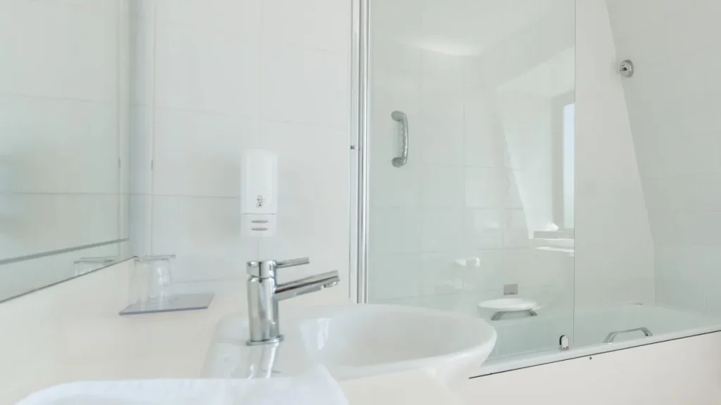 Clean en-suite bathroom with white sink, glass shower screen, and modern fittings at Marine Court Hotel Bangor Northern Ireland