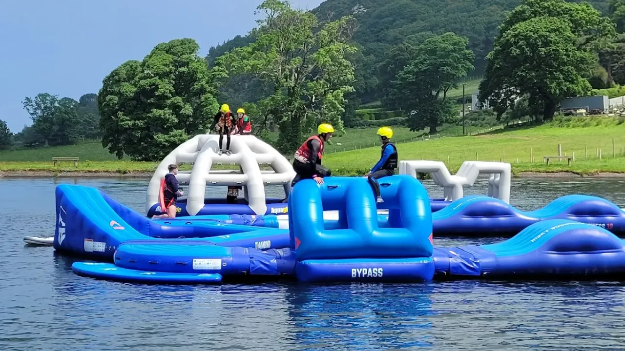 Group enjoying dome-shaped inflatable and balance features on the obstacle course at Sblash Aqua Park.