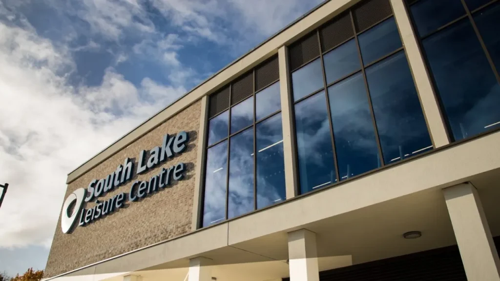 Exterior view of South Lake Leisure Centre Craigavon showing modern glass facade under blue sky