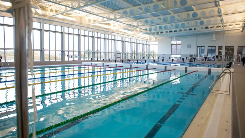 Bright indoor 50-metre swimming pool at South Lake Leisure Centre Craigavon with lane ropes and large windows