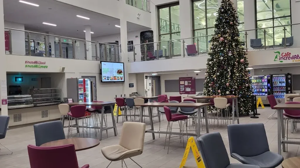 Indoor café area at South Lake Leisure Centre Craigavon with seating, vending machines, and a decorated Christmas tree