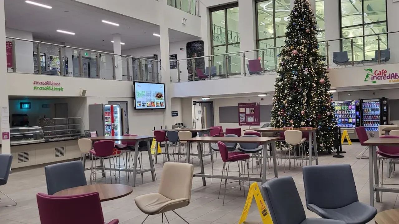 Indoor café area at South Lake Leisure Centre Craigavon with seating, vending machines, and a decorated Christmas tree