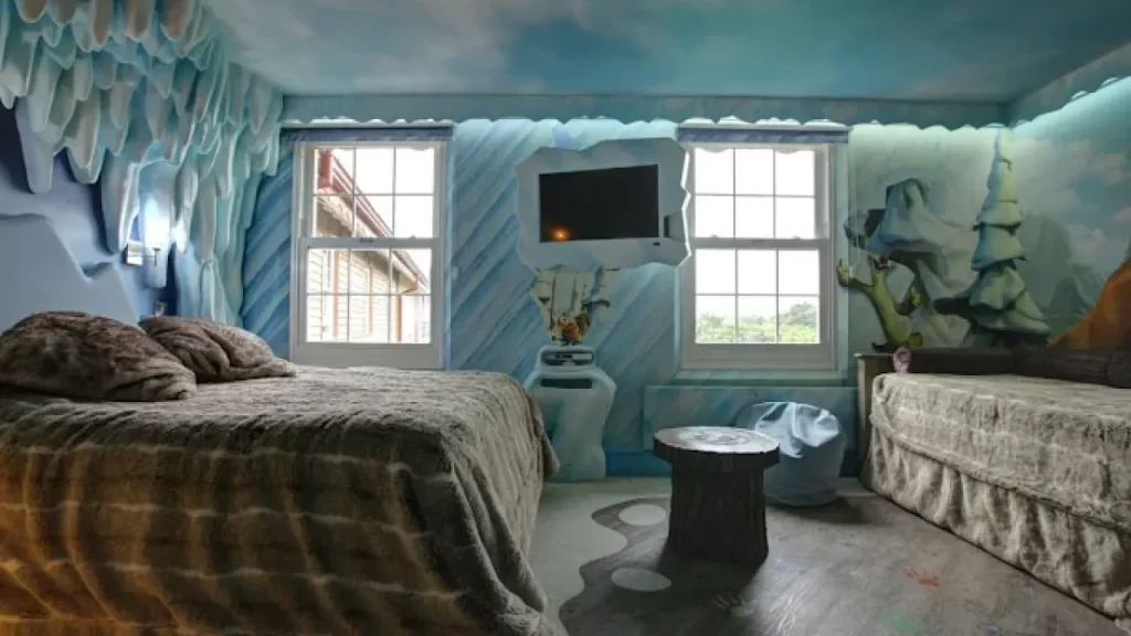 Immersive icy-themed family room at Splash Landings Hotel featuring frosted wall art, a themed TV console, and cosy sleeping space designed for children near Alton Towers.