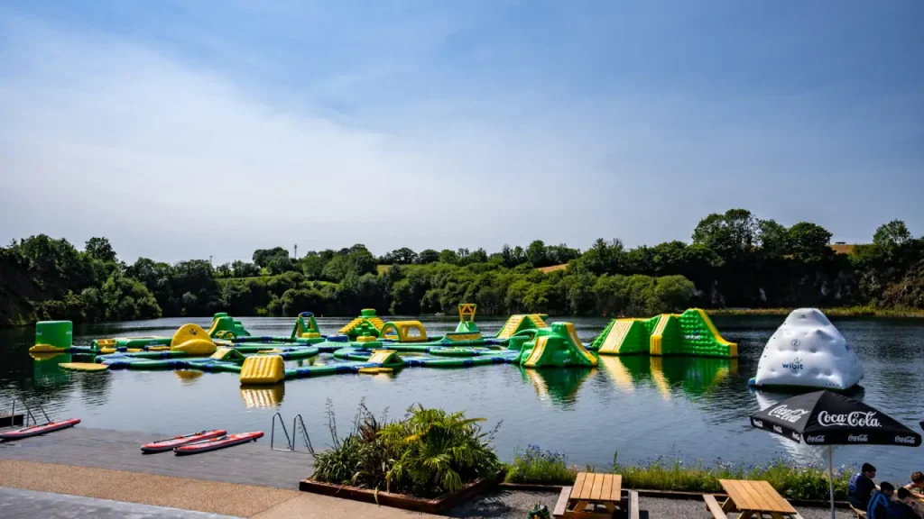 Inflatable AquaPark at Splash Outdoor Waterpark with slides, climbing towers and obstacle courses on a spring-fed lake in Northern Ireland.