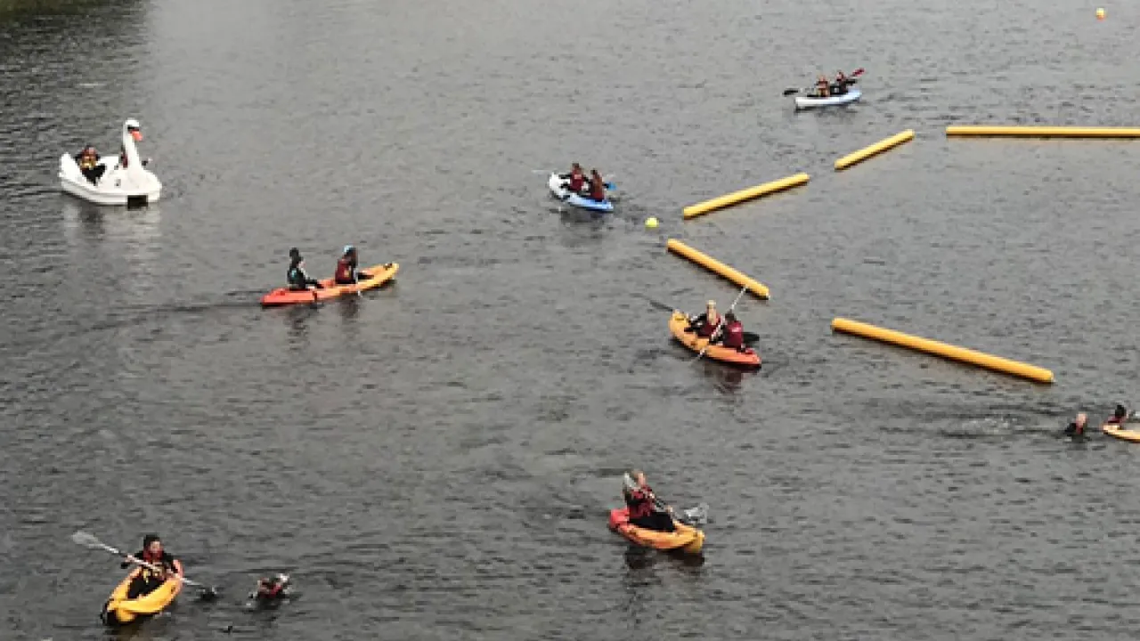 Paddlesports at the lake Kilrea waterpark — kayaks and a swan pedalo in the calm hire zone, a family-friendly alternative to the floating obstacle course.