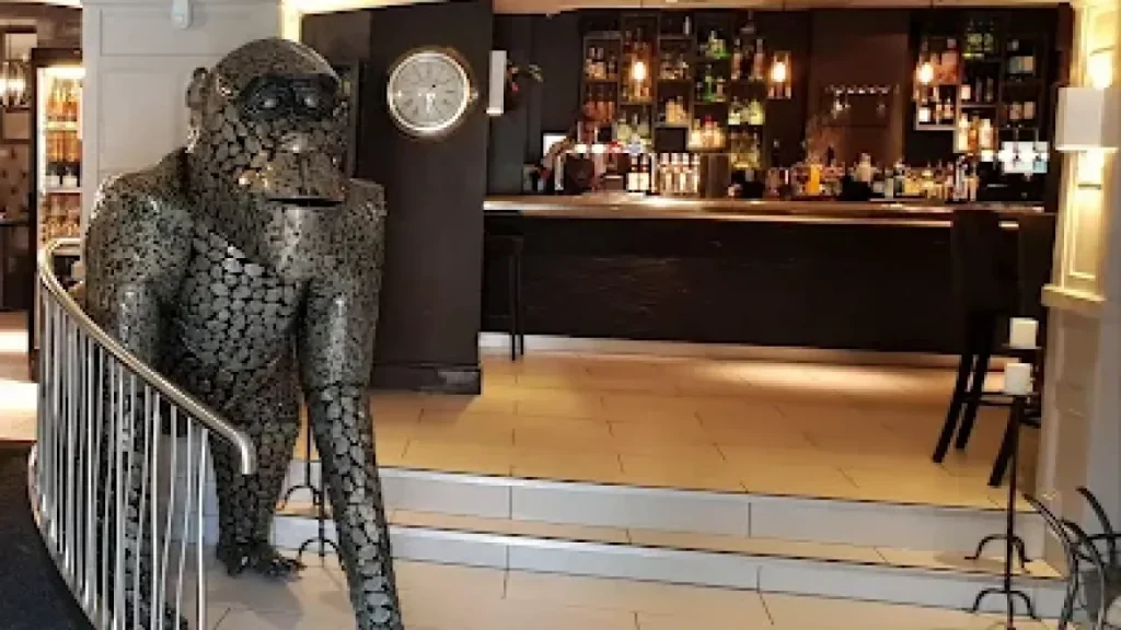 Bar lounge with gorilla sculpture and modern lighting at The White Hart Hotel near Alton Towers