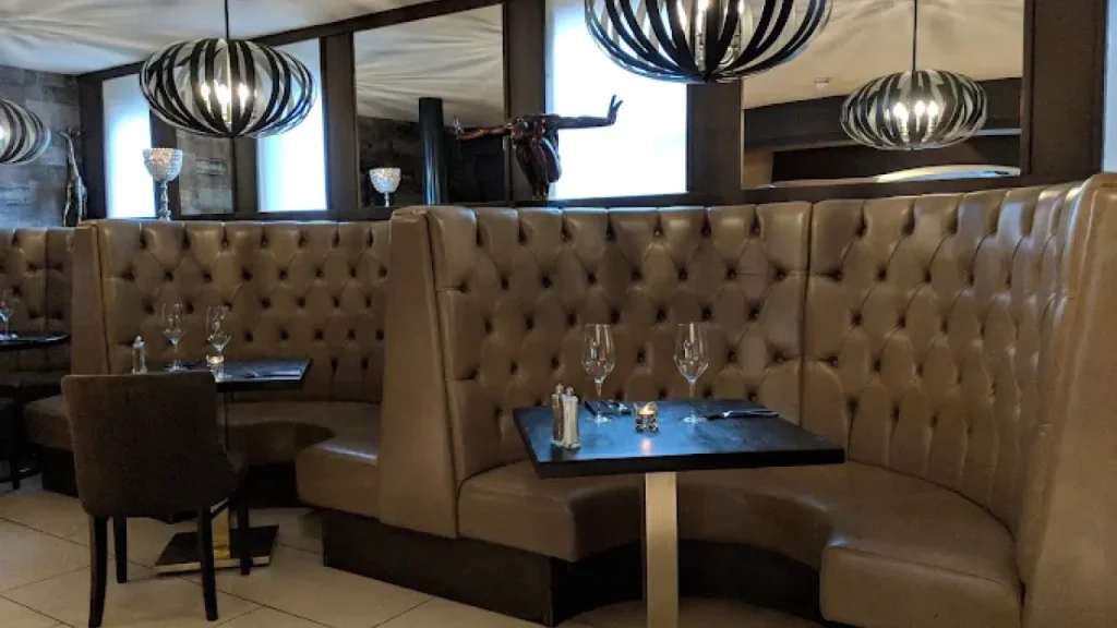 Luxurious leather dining booths with ambient lighting at The White Hart Hotel near Alton Towers