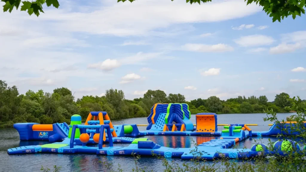 Scenic view of Aqua Action inflatable water park course floating on the lake at Fairlop Waters, Essex.