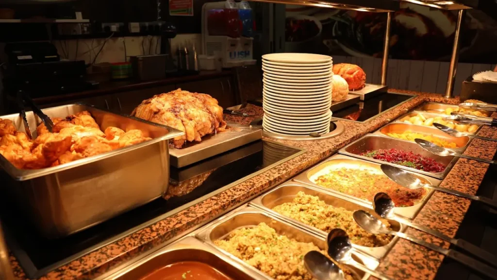 Close-up of buffet counter at The Tavern, Brean Leisure Park, featuring roast meats, stuffing, vegetables, gravy, and Yorkshire puddings.