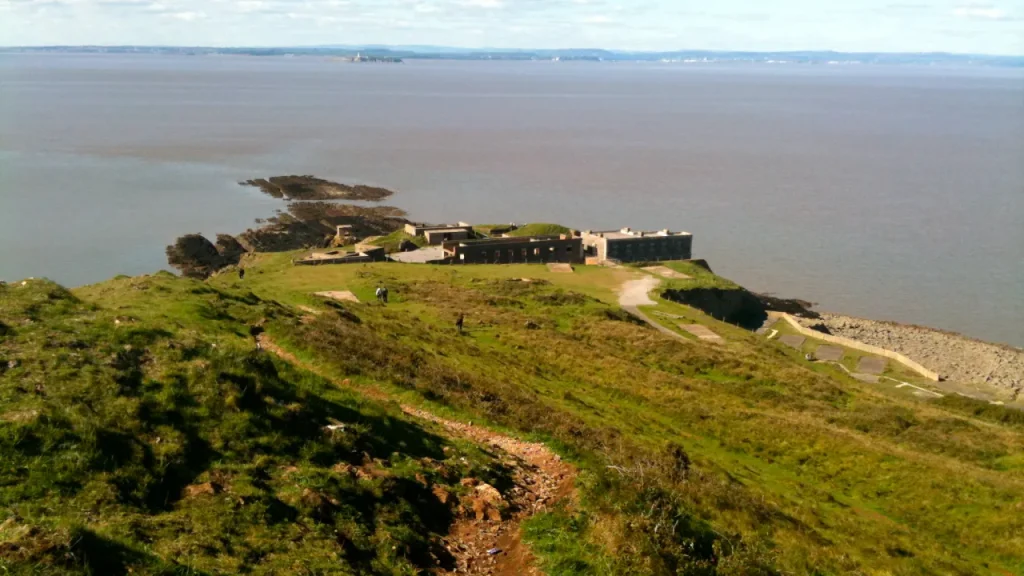 View of Brean Down Fort on the grassy headland above the Bristol Channel, showing Victorian military ruins and coastal scenery near Brean Leisure Park.