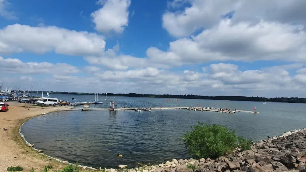 Jetty and sailing boats on Draycote Water under a partly cloudy sky.