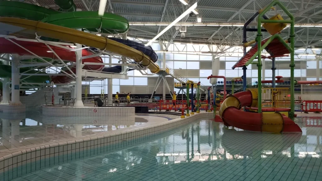 Interior of Dundee Olympia water park showing flumes, play equipment, and pool area for families.
