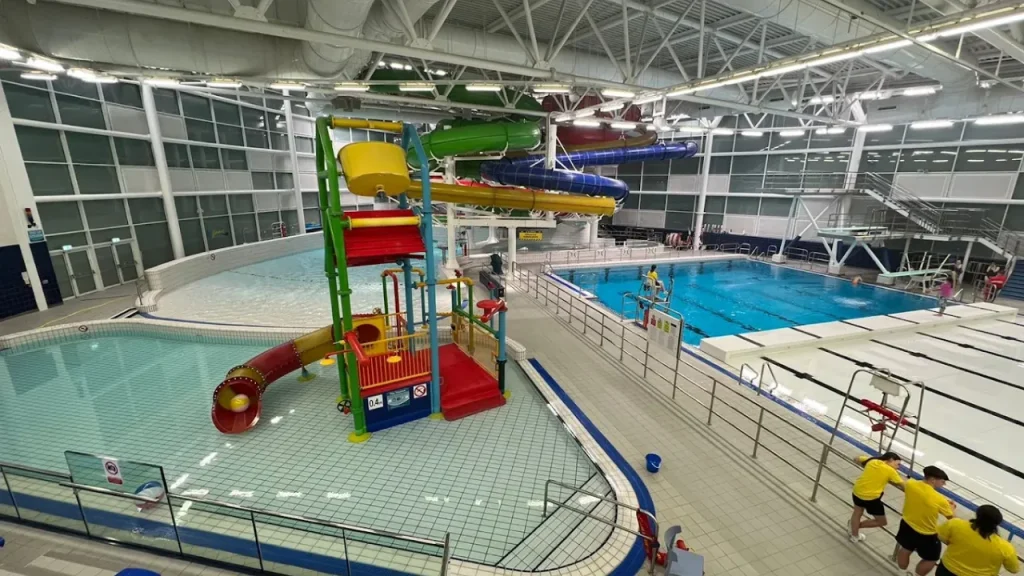 View of the toddler splash pool and multi-coloured flumes inside Dundee Olympia water park.