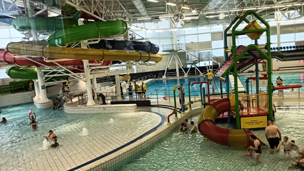 Curved water slides in red, green, yellow, and blue at Dundee Olympia indoor water park.