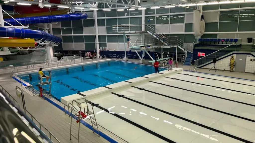 Diving pool with lifeguard and diving platforms at Dundee Olympia leisure centre.