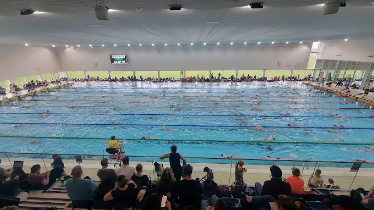 Competitive swimming event at Hengrove Park Leisure Centre viewed from the balcony seating area.