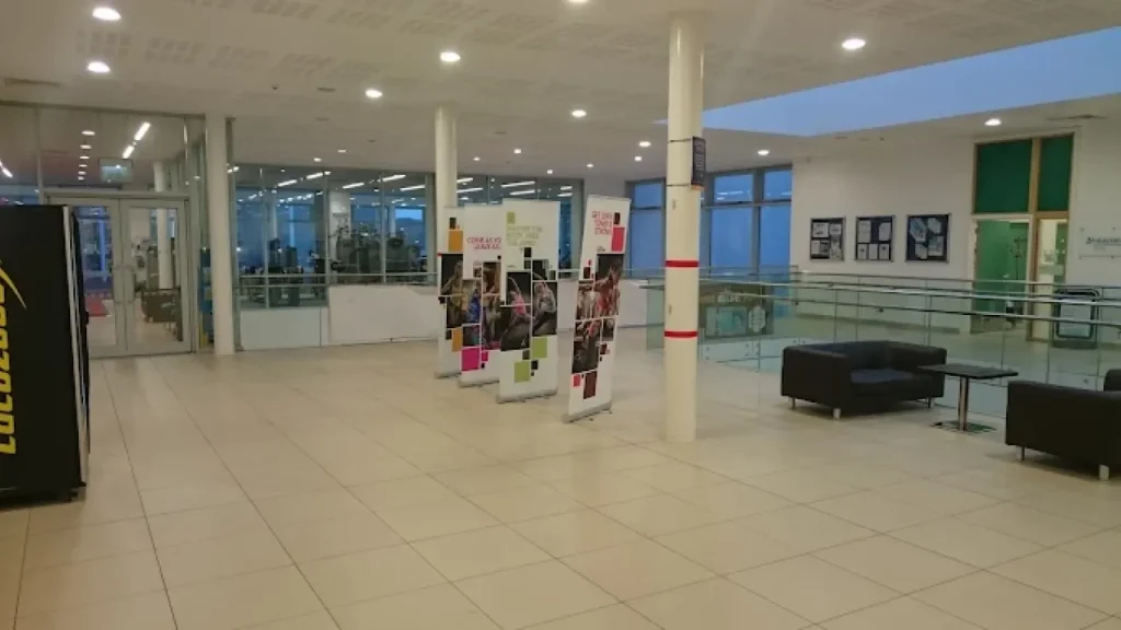 Reception foyer at Hengrove Park Leisure Centre with banners, seating, and large windows.
