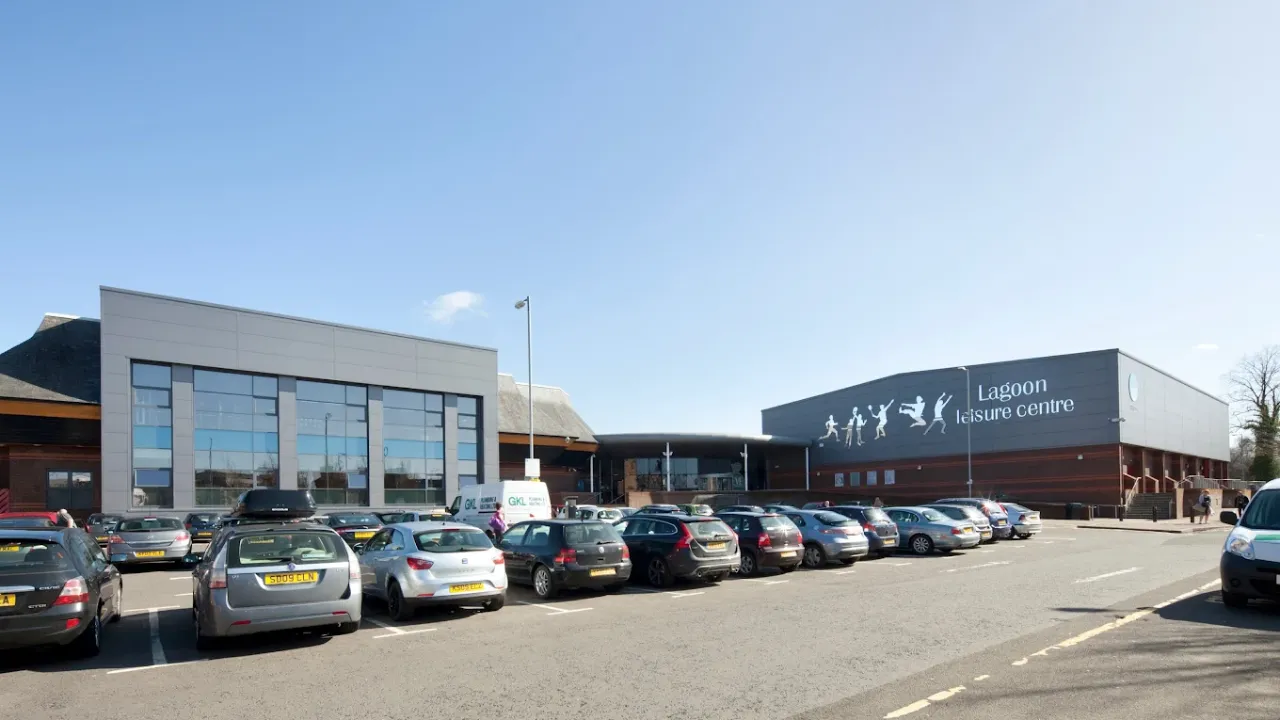 Lagoon Leisure Centre front entrance with modern glass facade and busy car park in Paisley, Renfrewshire.