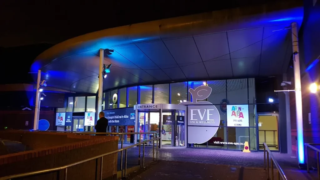 Eve Spa and Wellness Centre at Lagoon Leisure Centre illuminated at night with curved roof entrance.