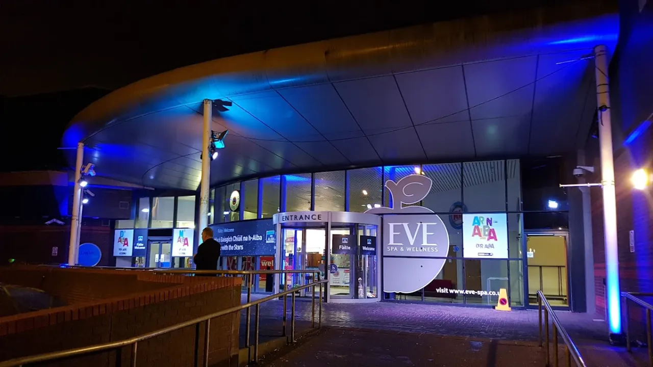 Eve Spa and Wellness Centre at Lagoon Leisure Centre illuminated at night with curved roof entrance.