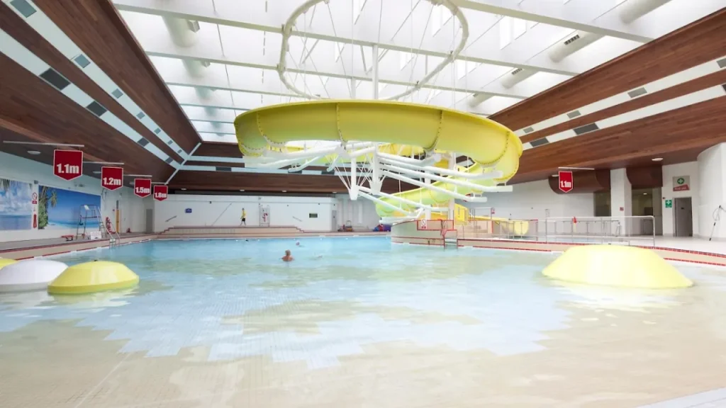 Lagoon Leisure Centre swimming pool with water slide, depth markers, and calm water during off-peak time.