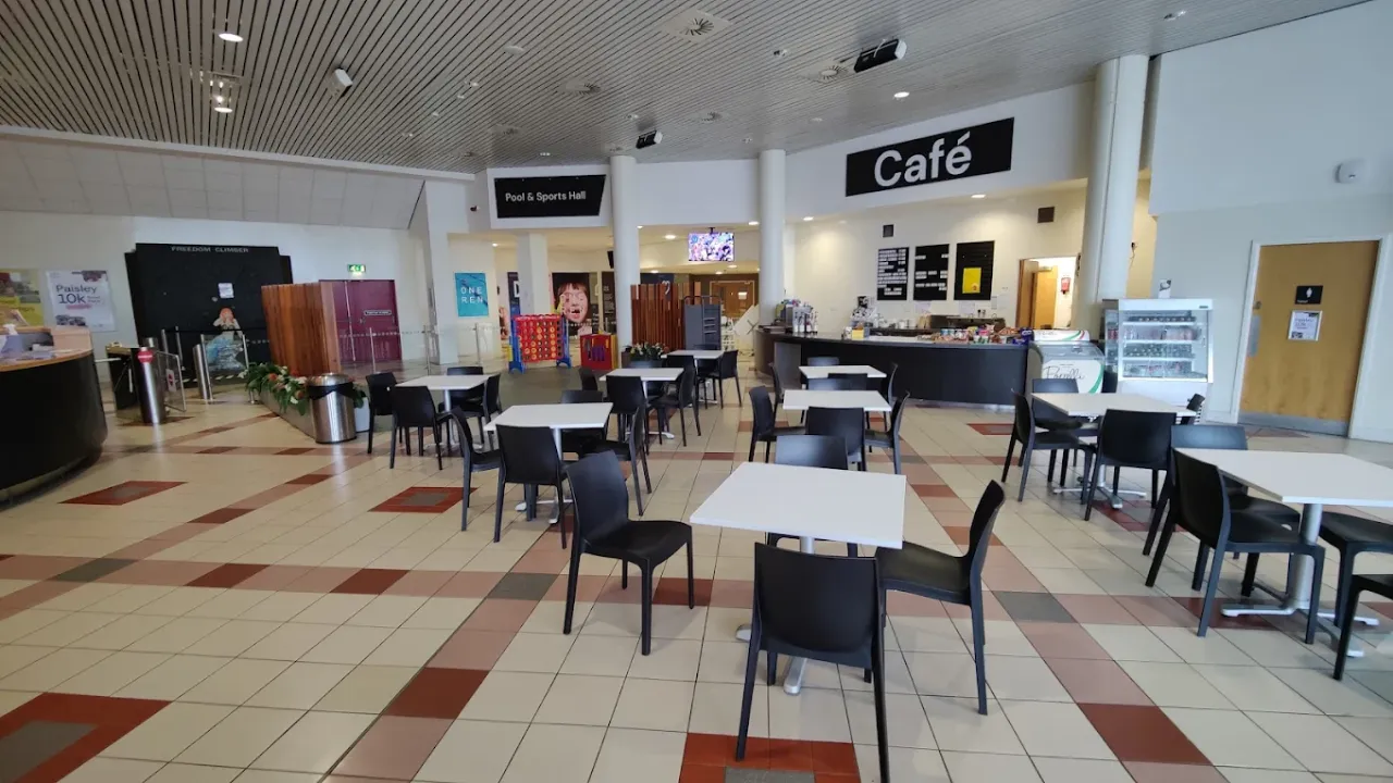 Lagoon Leisure Centre café with tables, chairs, food counter, and signs for the pool and sports hall.