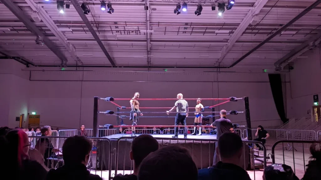 Wrestling match in progress at Lagoon Leisure Centre with crowd seated around the ring.