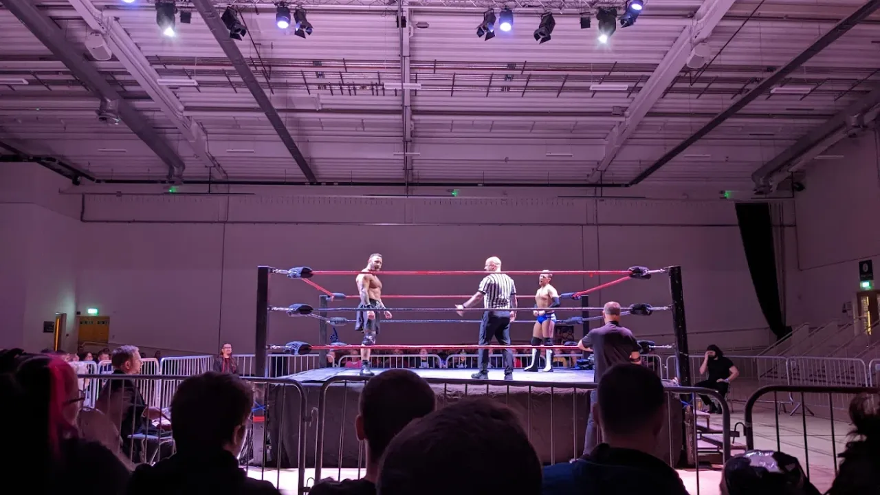 Wrestling match in progress at Lagoon Leisure Centre with crowd seated around the ring.