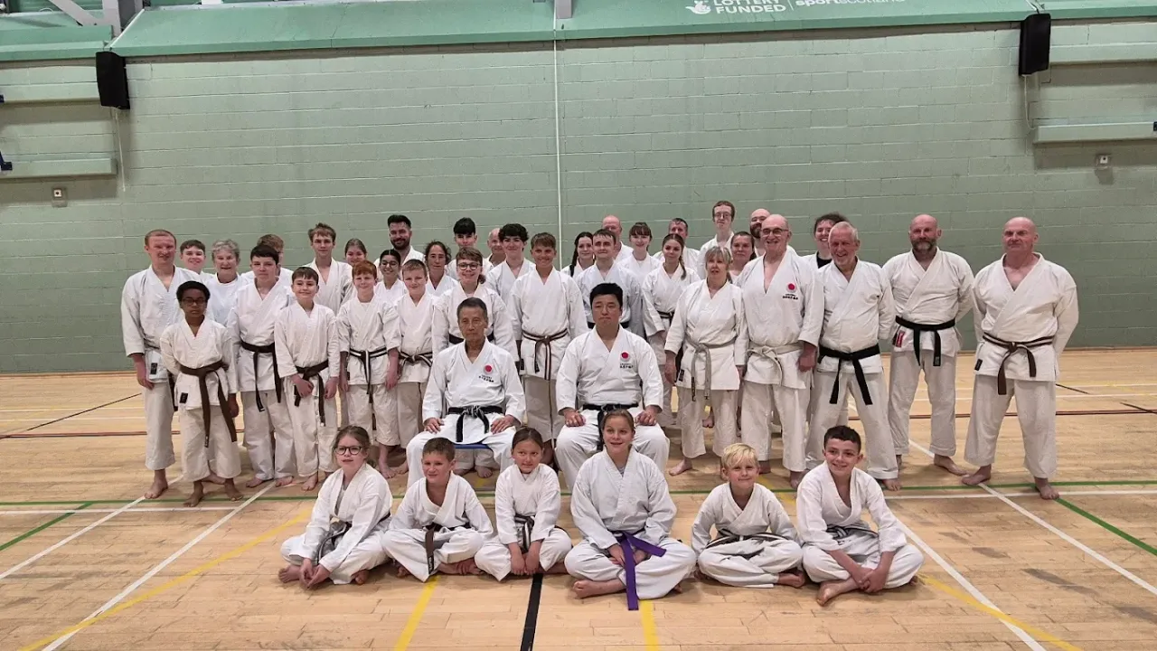 Karate class posing inside Lagoon Leisure Centre sports hall with students in traditional uniforms.