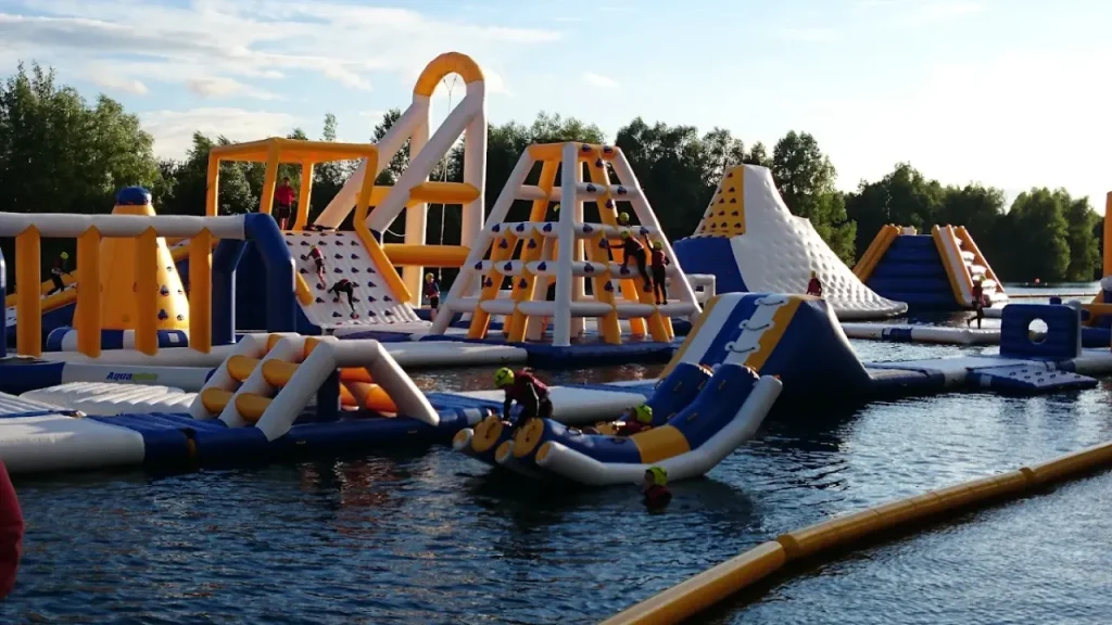 Blue, white and yellow inflatable climbing towers and water slides at Liquid Leisure Aqua Park.