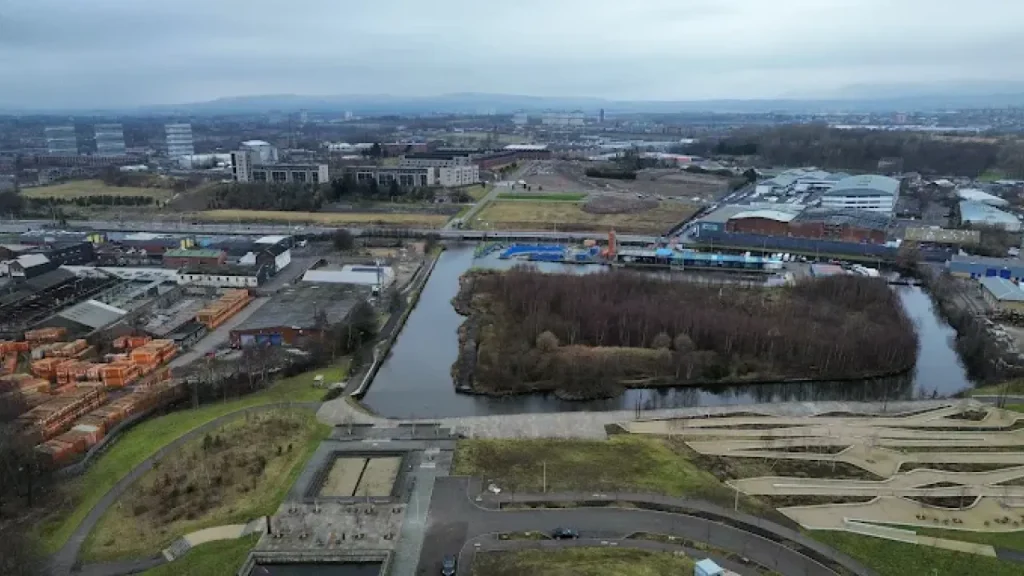 Wide shot of the artificial whitewater course at Pinkston Watersports in Glasgow under blue skies.
