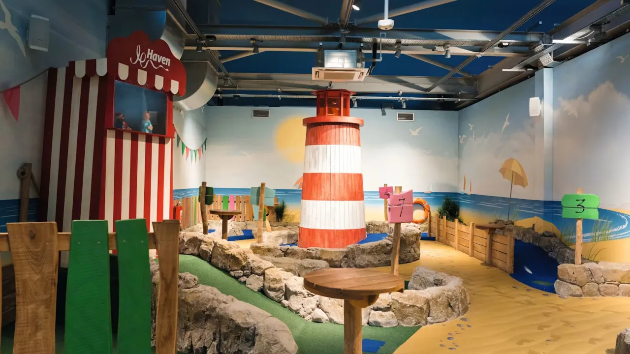 Indoor play area and mini golf with lighthouse decor at Craig Tara, close to Splashaway Bay.