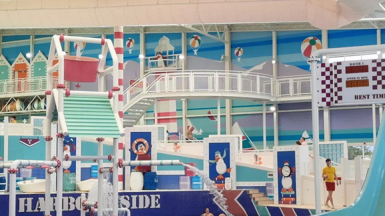 Interior of Splashaway Bay Craig Tara showing multi-level splash zone with water jets, buckets and seaside mural.