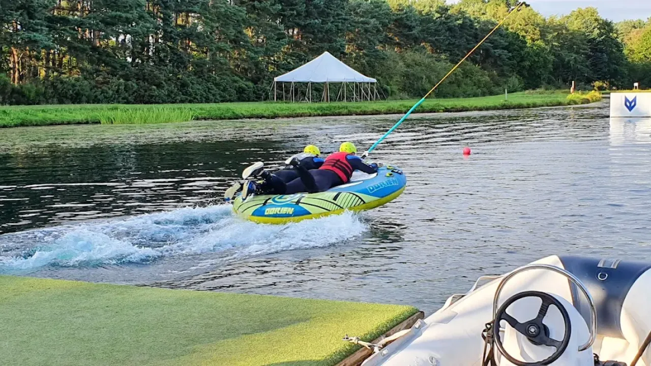 Guests riding the inflatable Ringo at Foxlake Adventures in Dunbar, Scotland, pulled at speed across the lake in full safety gear.