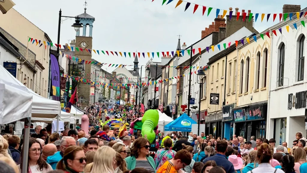 Ballymoney Spring Fair in Northern Ireland, with colourful bunting, market stalls, and crowds enjoying festivities along the town’s main street.