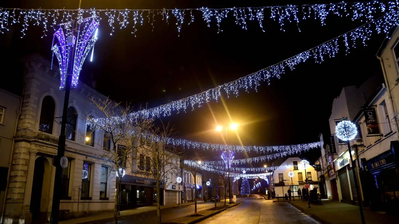 Ballymoney town centre at night decorated with Christmas lights and festive street displays in Northern Ireland.