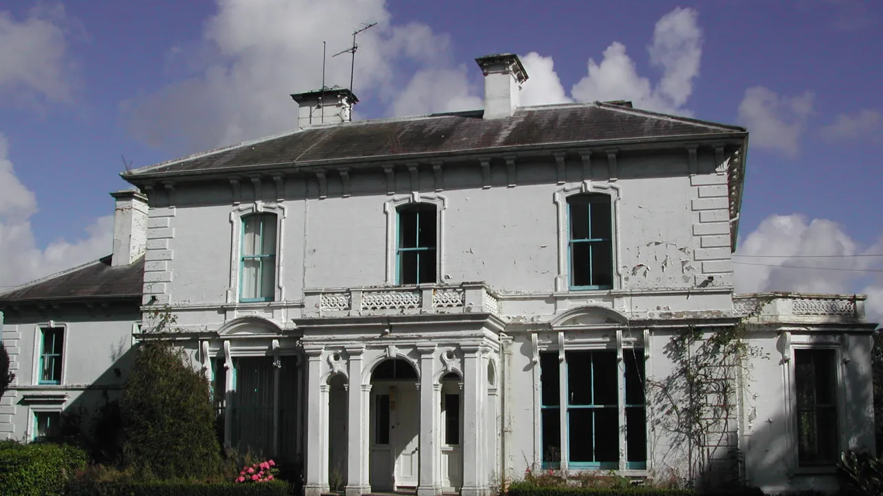 Leslie Hill, a historic Georgian country house in Ballymoney, Northern Ireland, with white façade and blue-trimmed windows.
