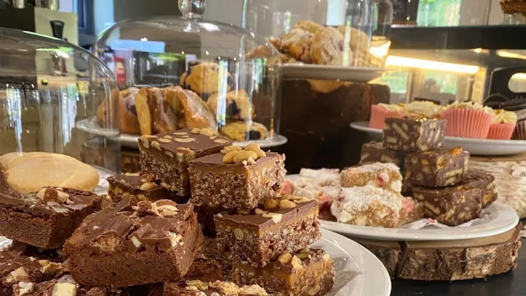 Selection of homemade traybakes, cakes, and pastries displayed at The Pantry café in Ballymoney, Northern Ireland.